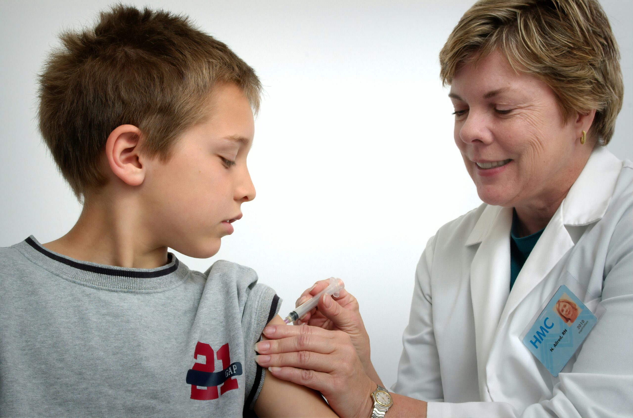 woman inject boy on arm